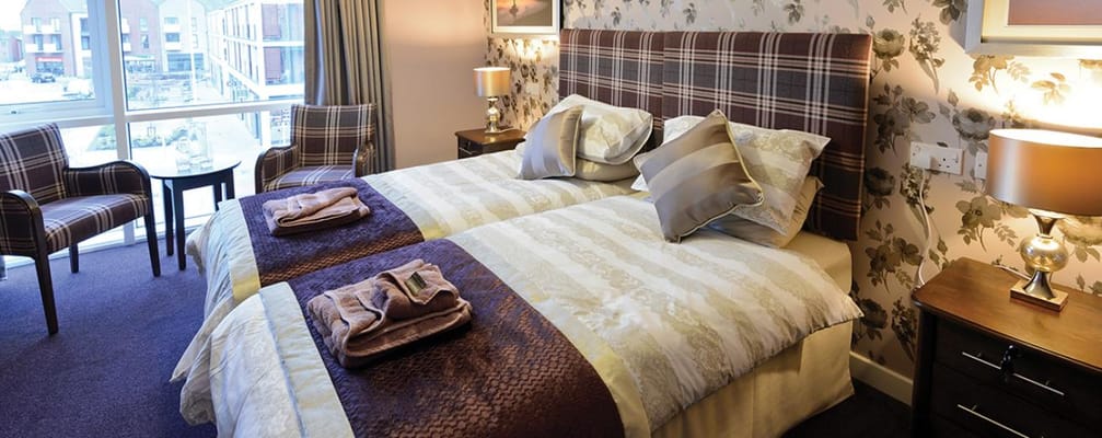 A well-decorated double room with two beds