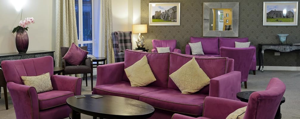 Cozy common area with purple sofas and decor