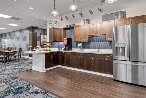 Modern kitchen area with cabinets and appliances