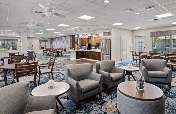 Spacious common area with seating and dining tables.