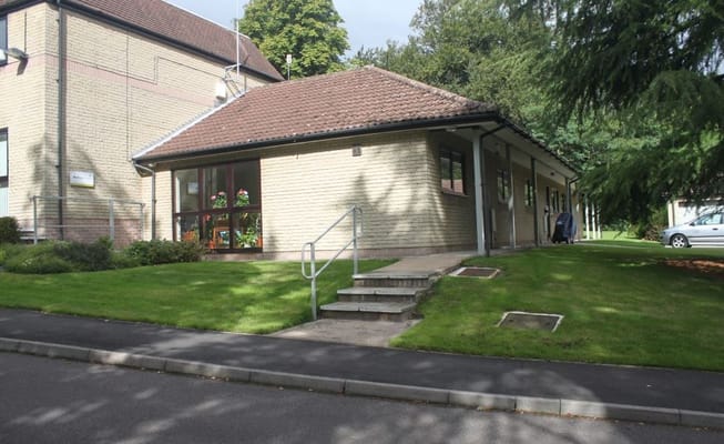 Exterior view of a senior living building with garden