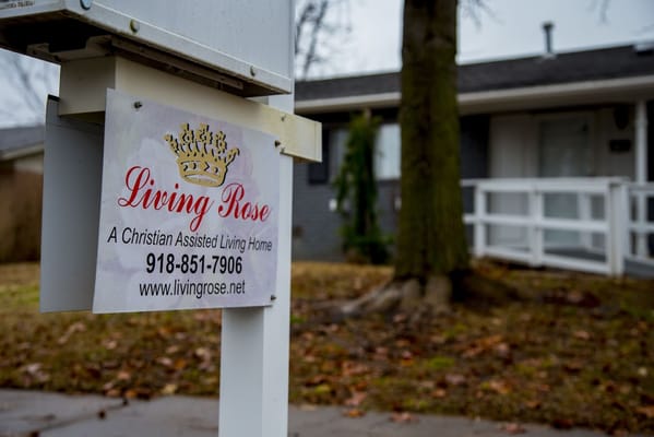 Sign for Living Rose Assisted Living Home outside a building