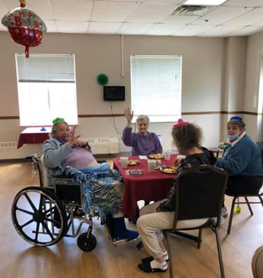 Residents celebrating a birthday with snacks
