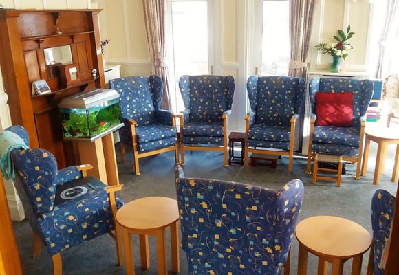 Common area with chairs and fish tank