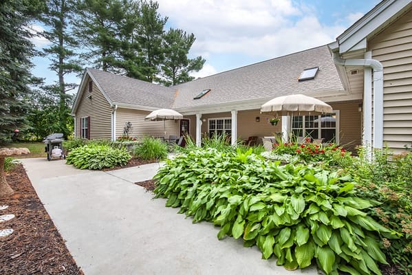 Outdoor patio area with greenery and umbrellas