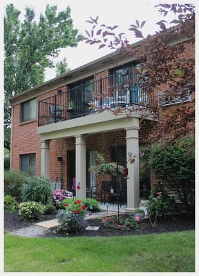 Exterior view of a senior living facility with gardens
