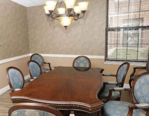 Elegant dining room with a wooden table and upholstered chairs