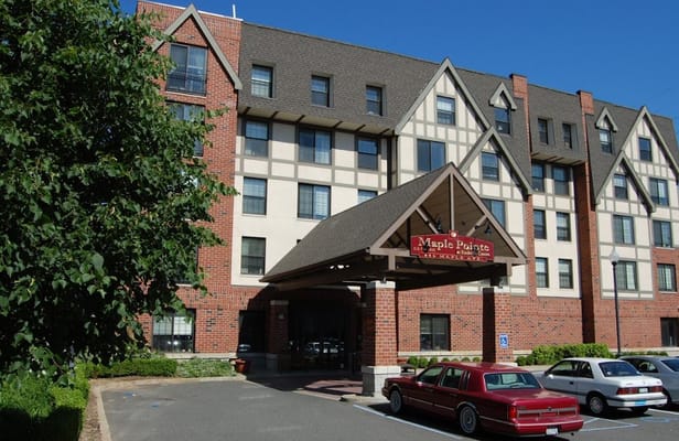 The entrance of Maple Pointe Senior Living facility showing its architectural design.