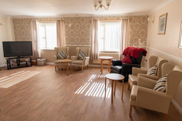 Bright common area with chairs and a television