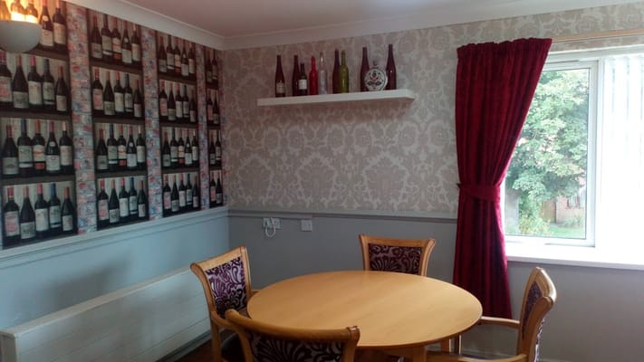 A cozy seating area with a round table and wine-themed decor