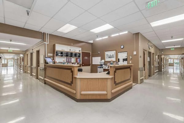 Interior view of a care facility hallway and reception area