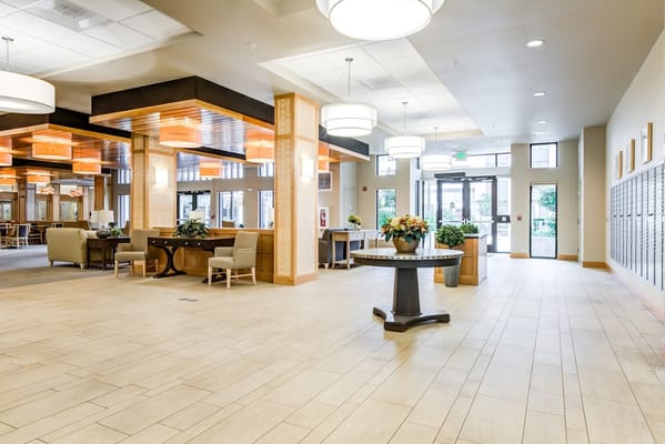 Bright lobby area of a senior living facility with seating