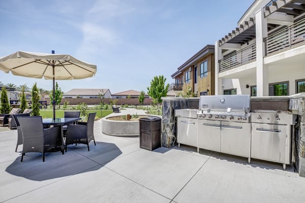 Outdoor patio area with grill and seating