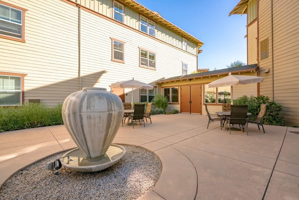Outdoor seating area with a fountain and umbrellas