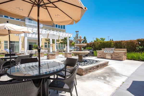 Outdoor seating area with fountain and grill