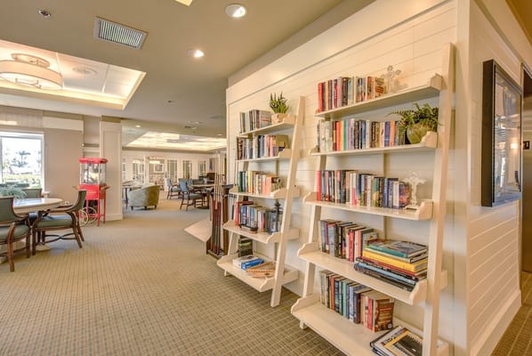 Bright common area with bookshelves and seating.