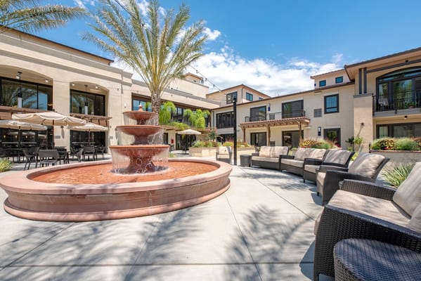 Outdoor courtyard with fountain and seating area