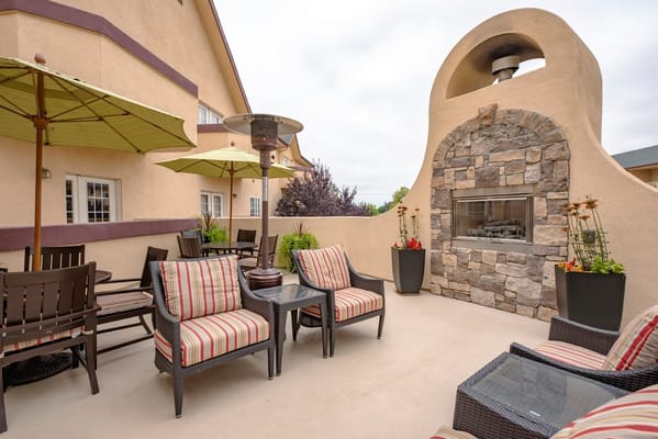 Outdoor patio area with seating and fireplace