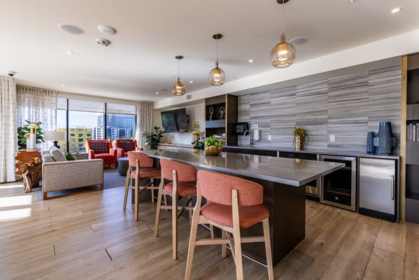 Bright and modern common area with seating and kitchenette