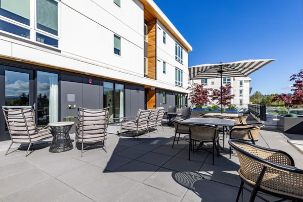 Outdoor seating area with chairs and umbrella