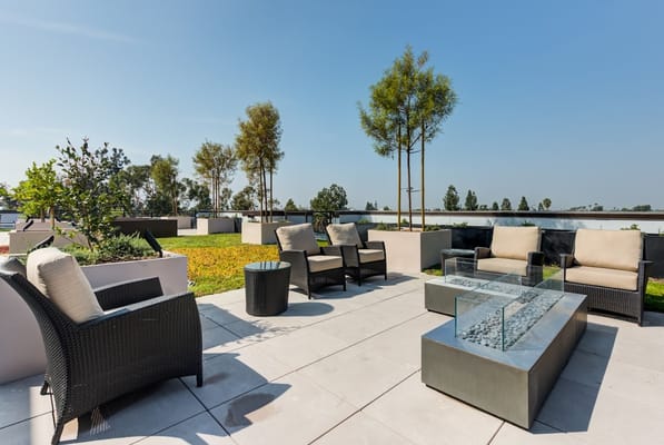 Outdoor lounge area with seating and trees