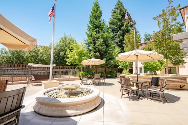 Outdoor seating area with umbrellas and fountain