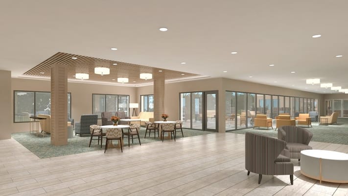 A bright common area with seating and tables