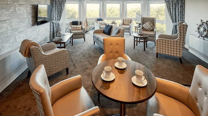 Bright common area with seating and coffee cups