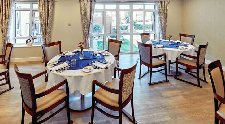 Dining room with tables set for residents