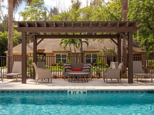 Outdoor seating area next to a pool