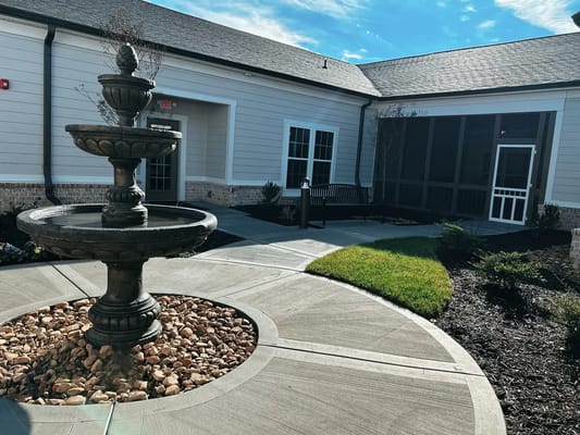 Outdoor courtyard with a fountain and seating area
