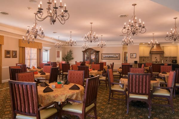 Dining area with elegant chandeliers and table settings