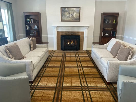 Common area with comfortable seating around a fireplace
