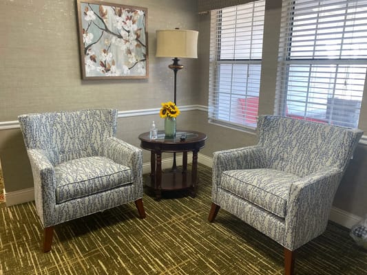 Cozy common area with armchairs and a lamp