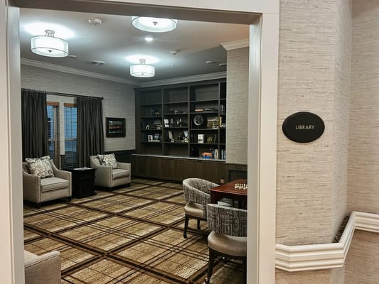 Cozy library with seating and shelves filled with books.