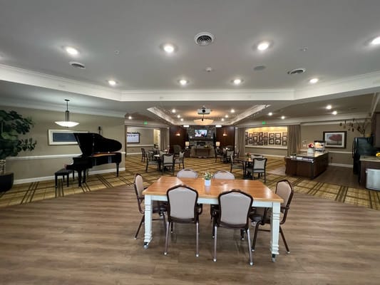 Interior view of a communal area with seating and a piano