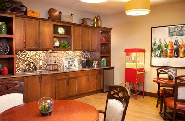 Interior view of a cozy common area with dining tables
