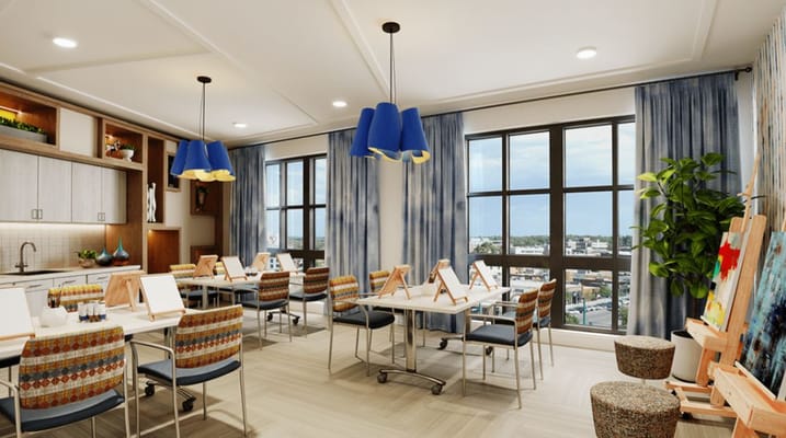 Bright interior activity room with art supplies and views