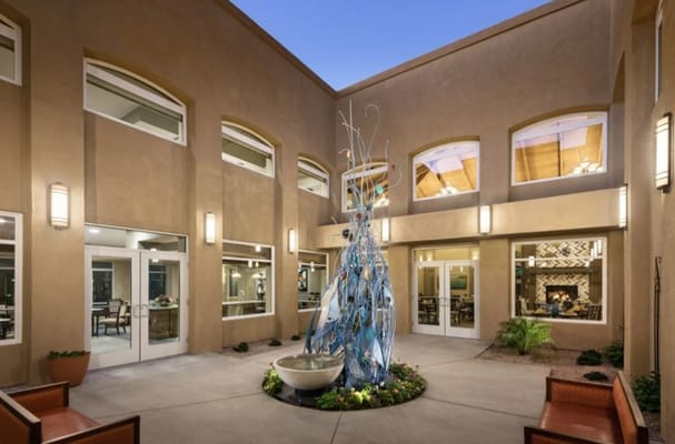 Outdoor seating area with a sculpture and courtyard
