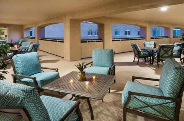 Outdoor seating area with turquoise chairs and plants
