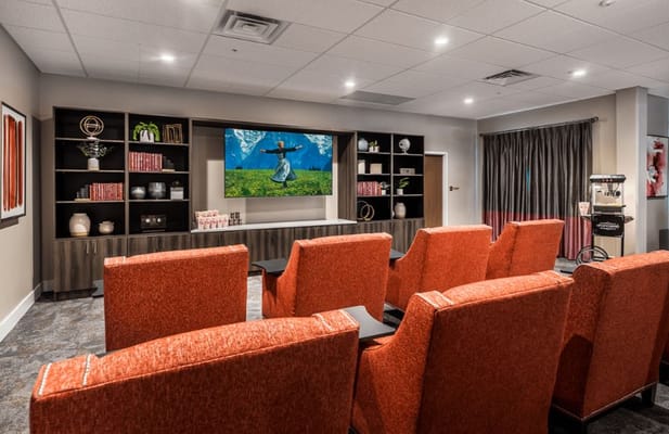 Interior of a cozy common area with orange chairs