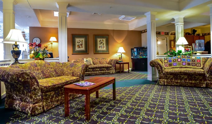 Cozy lounge area with floral sofas and decorative lamp