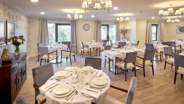 Elegant dining room set for a meal with flowers on the table