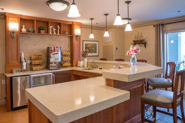 Bright kitchen area with modern cabinetry and seating