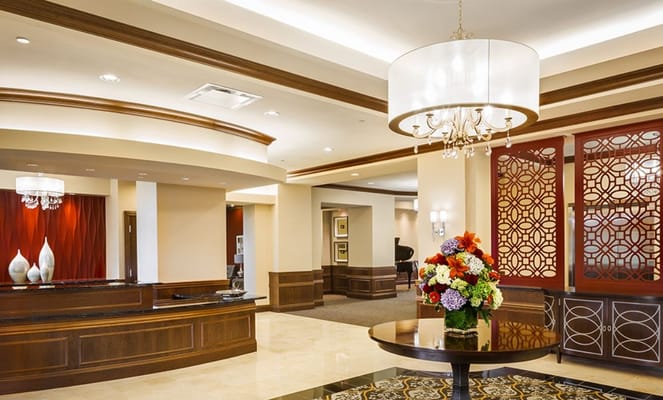 Elegant lobby with chandelier and floral arrangement