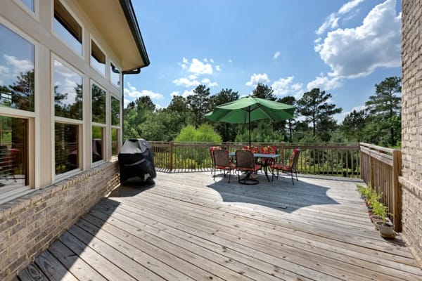 Outdoor deck area with seating and umbrella