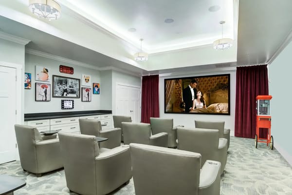 Interior common area with reclining chairs and large screen