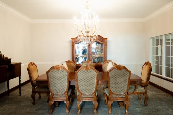 Elegant dining room with ornate furniture and chandelier