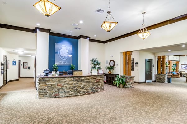 Bright lobby with a reception desk and common area