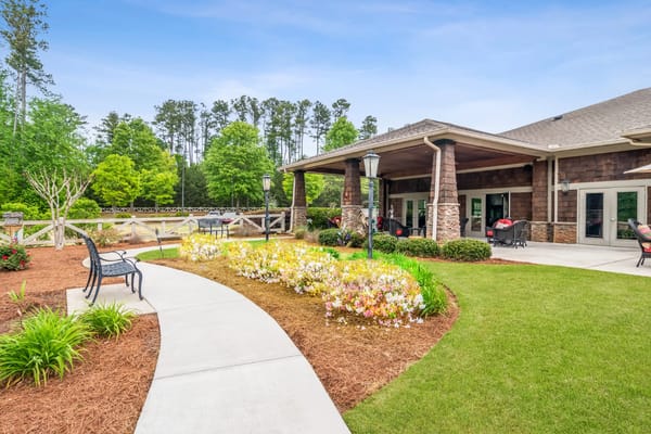 Outdoor seating area with flower beds and pathways